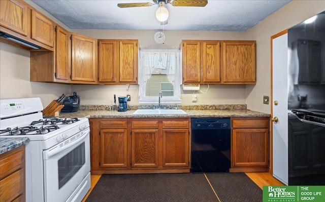 6070 Buckingham Ave, Omaha, NE 68117 - kitchen with black appliances, a sink, a ceiling fan, brown cabinetry, and light countertops