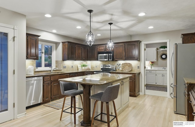 16712 V St, Omaha, NE 68135 - kitchen with stainless steel appliances, light wood finished floors, dark brown cabinetry, backsplash, and recessed lighting