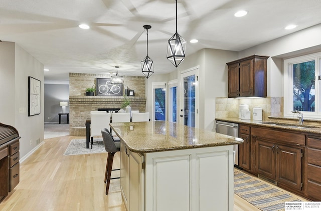 16712 V St, Omaha, NE 68135 - kitchen with a sink, light wood-type flooring, light stone countertops, a kitchen island, and backsplash
