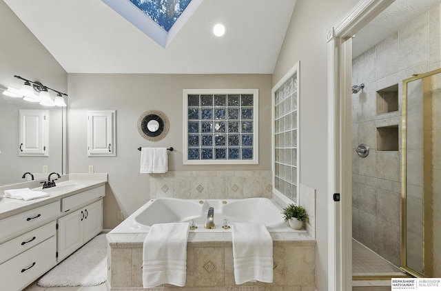 16712 V St, Omaha, NE 68135 - bathroom featuring vanity, a bath, a stall shower, a skylight, and vaulted ceiling