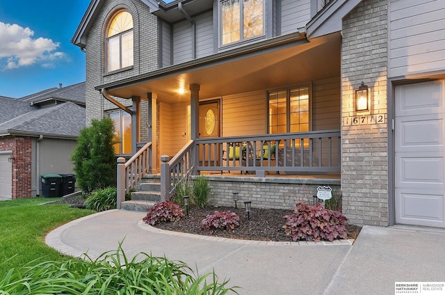 16712 V St, Omaha, NE 68135 - property entrance with a porch and a garage