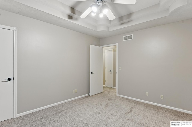 16712 V St, Omaha, NE 68135 - spare room featuring a tray ceiling, a ceiling fan, carpet, and baseboards