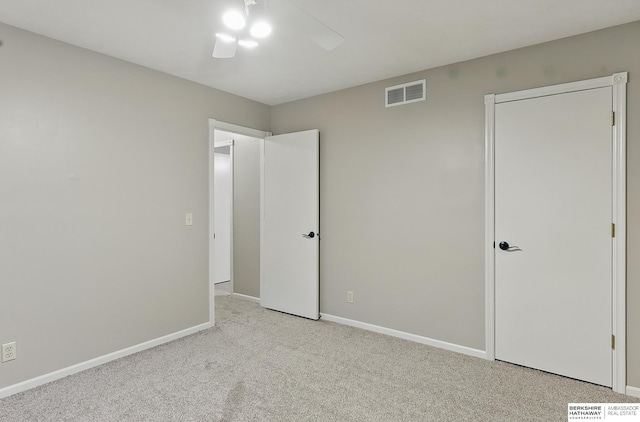 16712 V St, Omaha, NE 68135 - unfurnished bedroom featuring light carpet, baseboards, and ceiling fan