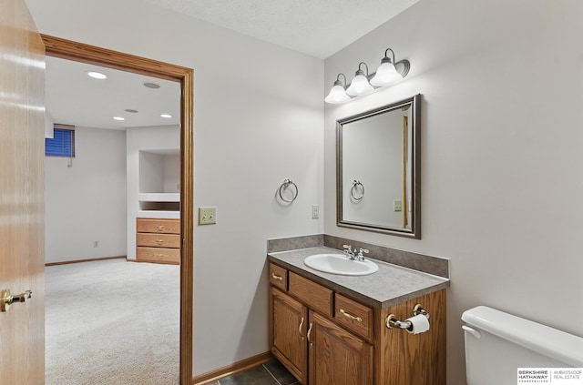 16712 V St, Omaha, NE 68135 - half bathroom featuring vanity, toilet, baseboards, and recessed lighting