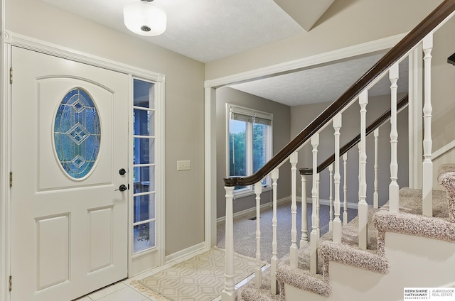 16712 V St, Omaha, NE 68135 - foyer entrance with stairway, baseboards, and a textured ceiling