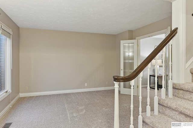 16712 V St, Omaha, NE 68135 - stairway featuring carpet floors, baseboards, and a textured ceiling