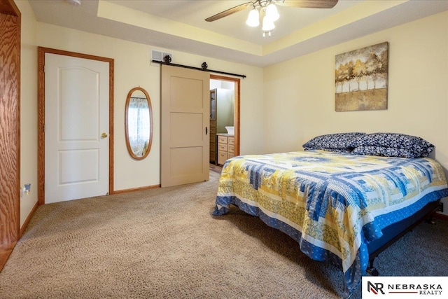 650 Heatherwood Dr, Fremont, NE 68025 - bedroom with light colored carpet, a barn door, baseboards, a ceiling fan, and a raised ceiling