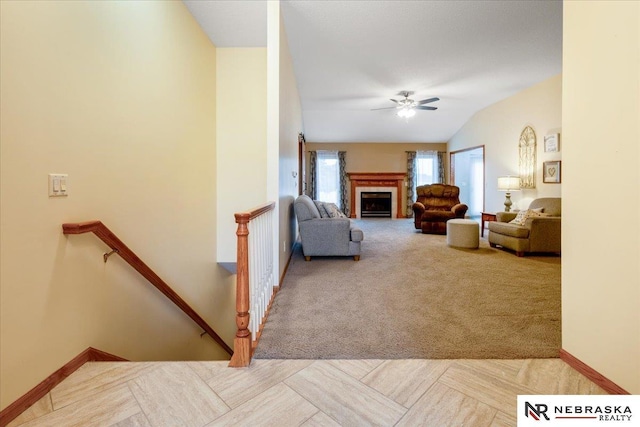 650 Heatherwood Dr, Fremont, NE 68025 - carpeted living room with a ceiling fan, baseboards, a fireplace, and lofted ceiling