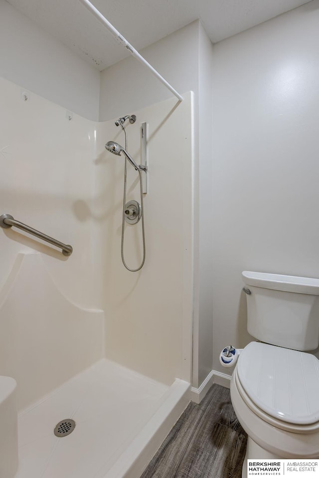 15010 Normandy Blvd, Bellevue, NE 68123 - bathroom with a shower stall, toilet, wood finished floors, and baseboards