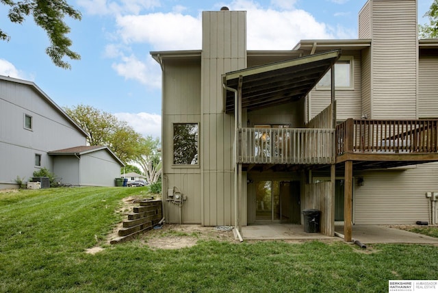 15010 Normandy Blvd, Bellevue, NE 68123 - rear view of property featuring a chimney, a lawn, a patio area, central air condition unit, and a deck