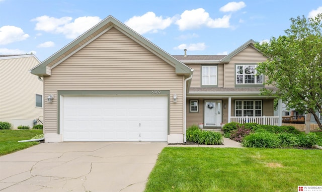 6909 S 152nd St, Omaha, NE 68138 - traditional-style house featuring driveway, covered porch, a front lawn, and an attached garage