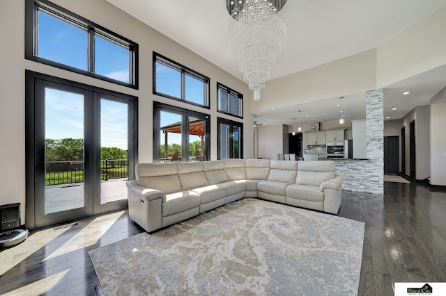 17380 S 77th Pt, Hickman, NE 68372 - living room featuring a chandelier, a high ceiling, and wood-type flooring