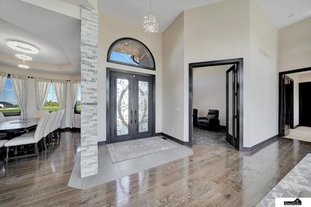 17380 S 77th Pt, Hickman, NE 68372 - foyer entrance with a chandelier, wood finished floors, a high ceiling, and baseboards