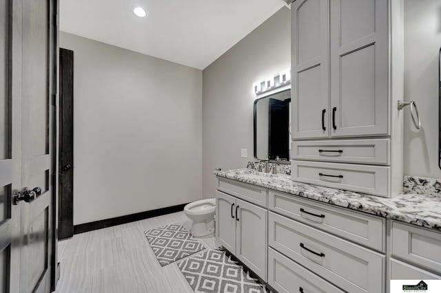 17380 S 77th Pt, Hickman, NE 68372 - bathroom with vanity, baseboards, toilet, and recessed lighting