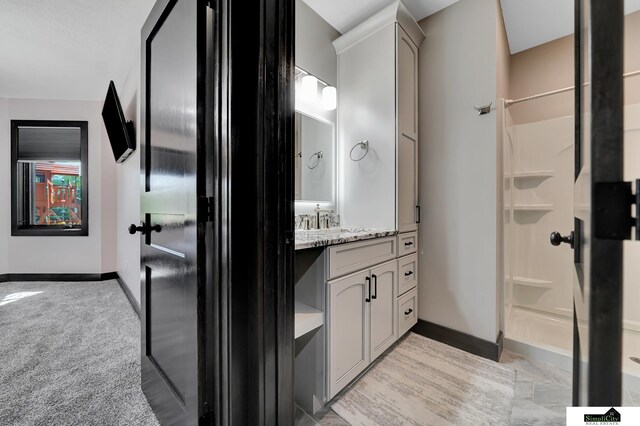 17380 S 77th Pt, Hickman, NE 68372 - bathroom with baseboards, a shower, and vanity