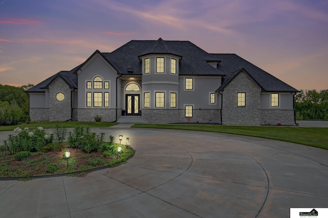 17380 S 77th Pt, Hickman, NE 68372 - french provincial home with stone siding, stucco siding, curved driveway, french doors, and a lawn