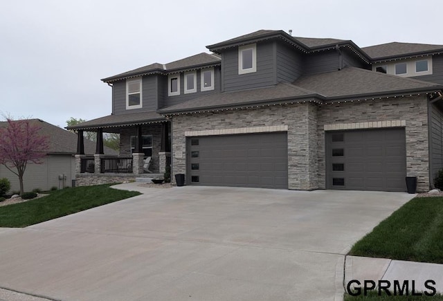 5815 S 238th St, Elkhorn, NE 68022 - prairie-style home with concrete driveway, a porch, stone siding, and roof with shingles