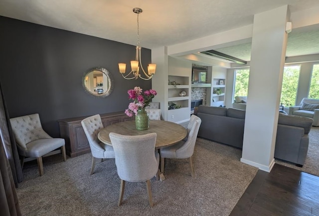 5815 S 238th St, Elkhorn, NE 68022 - dining space featuring a chandelier, built in features, wood finished floors, a fireplace, and baseboards