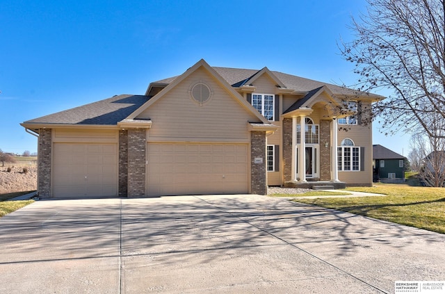 4804 Fountain Cir, Papillion, NE 68133 - view of front of property featuring a garage, brick siding, concrete driveway, and a front yard