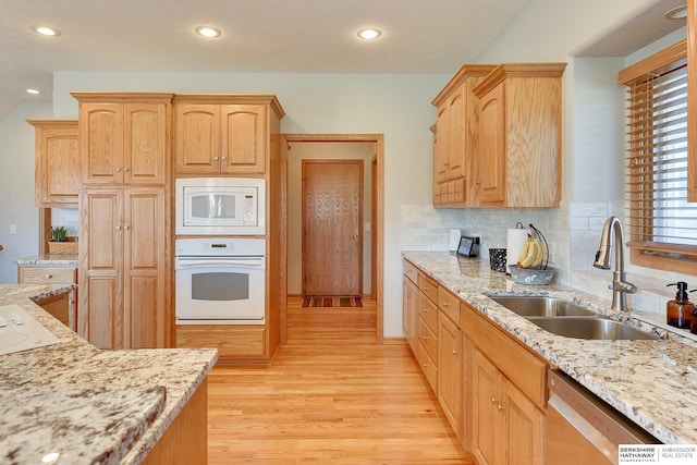 4804 Fountain Cir, Papillion, NE 68133 - kitchen featuring white appliances, a sink, light brown cabinets, light wood-style floors, and light stone counters