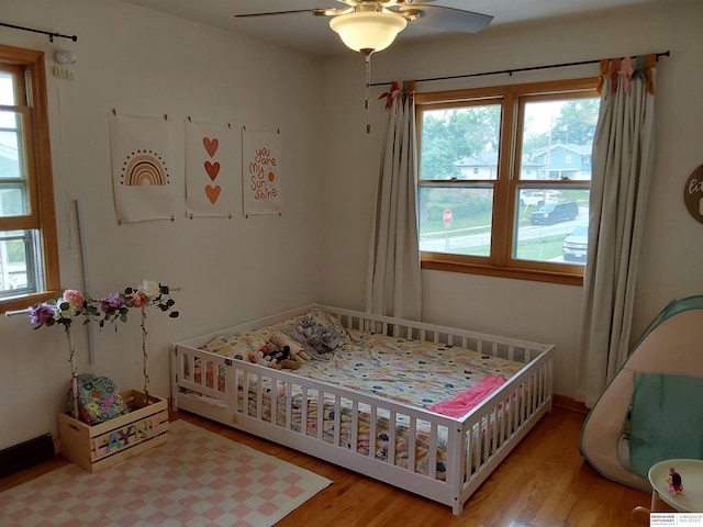 7027 S 39th Ave, Bellevue, NE 68147 - bedroom featuring wood finished floors and ceiling fan