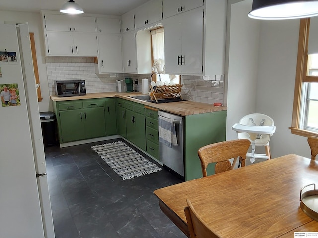 7027 S 39th Ave, Bellevue, NE 68147 - kitchen featuring dishwasher, freestanding refrigerator, green cabinets, backsplash, and white cabinetry