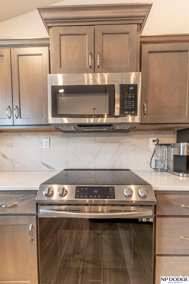 8111 S 198th St, Gretna, NE 68028 - kitchen featuring stainless steel appliances, backsplash, and light countertops