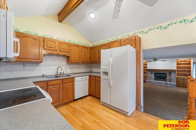 3412 Rahn Blvd, Bellevue, NE 68123 - kitchen featuring white appliances, a sink, ceiling fan, light wood-type flooring, and a brick fireplace