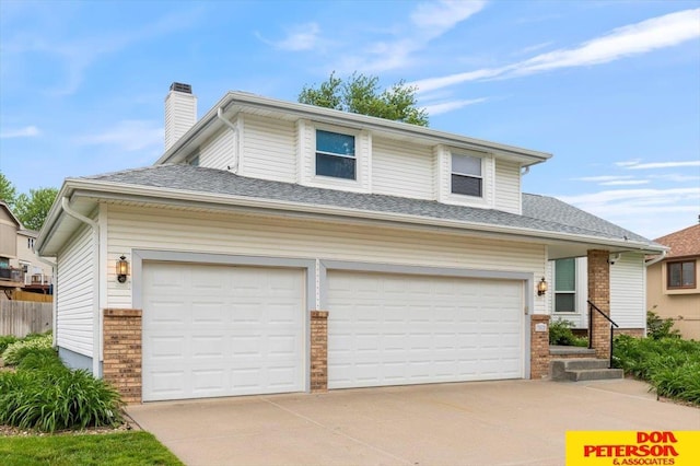 3412 Rahn Blvd, Bellevue, NE 68123 - view of front of house featuring brick siding, a chimney, concrete driveway, and a garage
