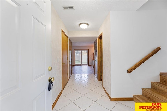 3412 Rahn Blvd, Bellevue, NE 68123 - hallway with baseboards, light tile patterned floors, and stairs