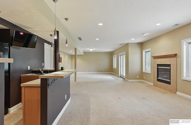 10022 S 177th St, Omaha, NE 68136 - kitchen featuring a fireplace, open floor plan, baseboards, light carpet, and recessed lighting