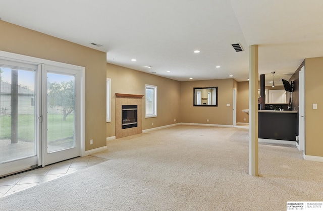 10022 S 177th St, Omaha, NE 68136 - unfurnished living room featuring light carpet, baseboards, recessed lighting, a fireplace, and light tile patterned flooring