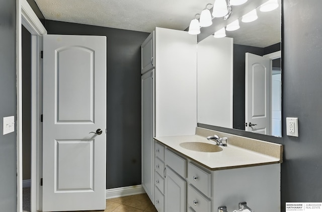 10022 S 177th St, Omaha, NE 68136 - bathroom with vanity, tile patterned flooring, baseboards, and a textured ceiling