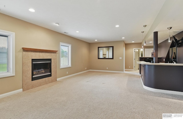 10022 S 177th St, Omaha, NE 68136 - unfurnished living room with carpet floors, baseboards, recessed lighting, and a tiled fireplace