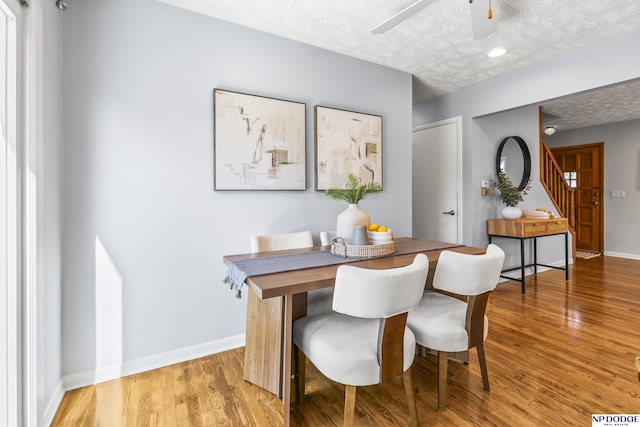 8207 Decatur St, Omaha, NE 68114 - dining room featuring a textured ceiling, light wood-type flooring, ceiling fan, and baseboards