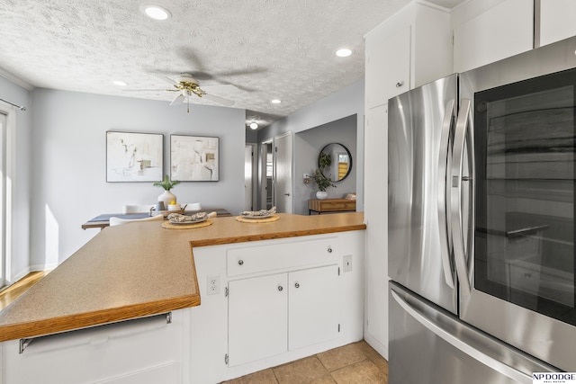 8207 Decatur St, Omaha, NE 68114 - kitchen with smart refrigerator, a peninsula, ceiling fan, a textured ceiling, and white cabinets