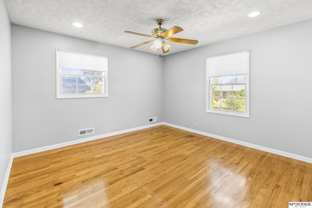 8207 Decatur St, Omaha, NE 68114 - empty room with light wood-style floors, baseboards, a textured ceiling, a ceiling fan, and recessed lighting