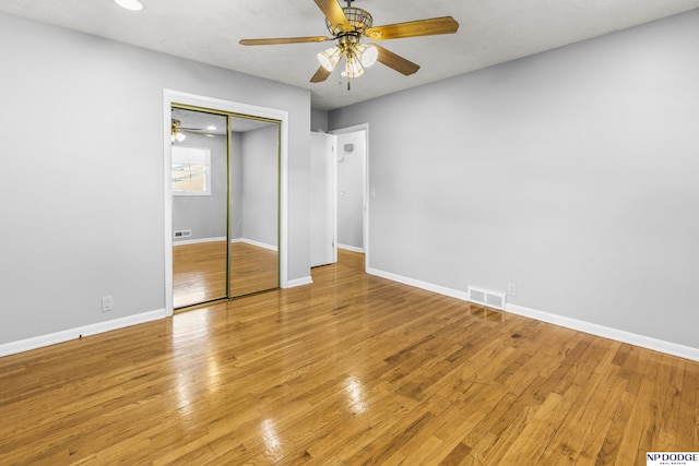 8207 Decatur St, Omaha, NE 68114 - unfurnished bedroom with a closet, baseboards, light wood-style floors, and a ceiling fan