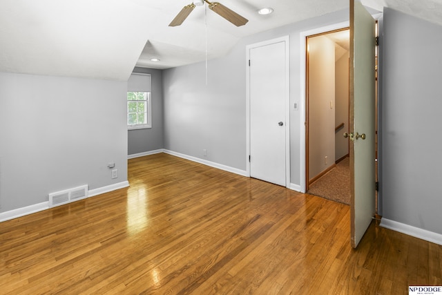 8207 Decatur St, Omaha, NE 68114 - unfurnished bedroom with wood finished floors, vaulted ceiling, baseboards, and ceiling fan