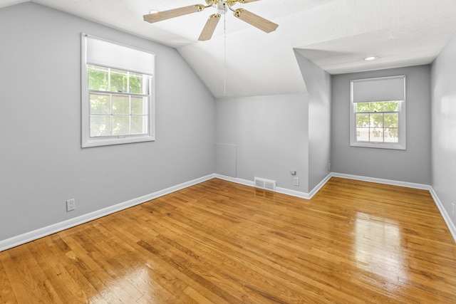 8207 Decatur St, Omaha, NE 68114 - additional living space with lofted ceiling, healthy amount of natural light, wood finished floors, and baseboards