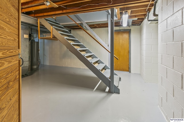 8207 Decatur St, Omaha, NE 68114 - basement with water heater, stairway, and concrete block wall