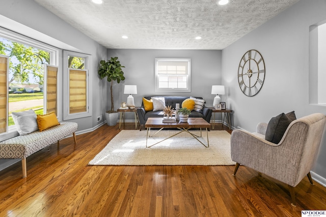 8207 Decatur St, Omaha, NE 68114 - living area with a textured ceiling, recessed lighting, baseboards, and wood finished floors