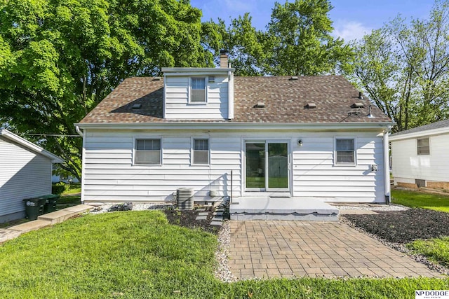 8207 Decatur St, Omaha, NE 68114 - rear view of house featuring a chimney, a patio, a yard, and roof with shingles