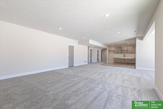 5729 N 196th St, Elkhorn, NE 68022 - unfurnished living room featuring recessed lighting, light carpet, and baseboards