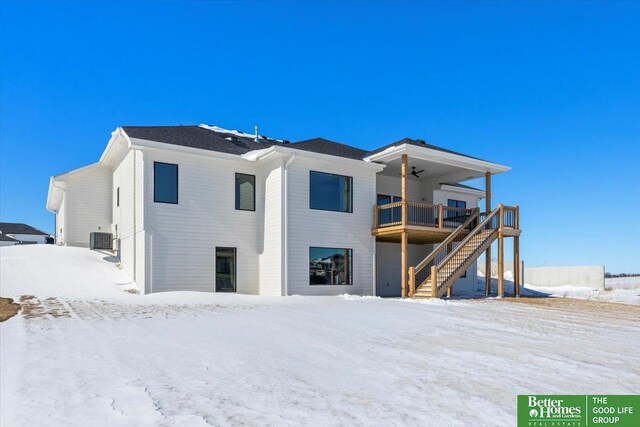 5729 N 196th St, Elkhorn, NE 68022 - snow covered house with a ceiling fan, stairs, and central AC unit