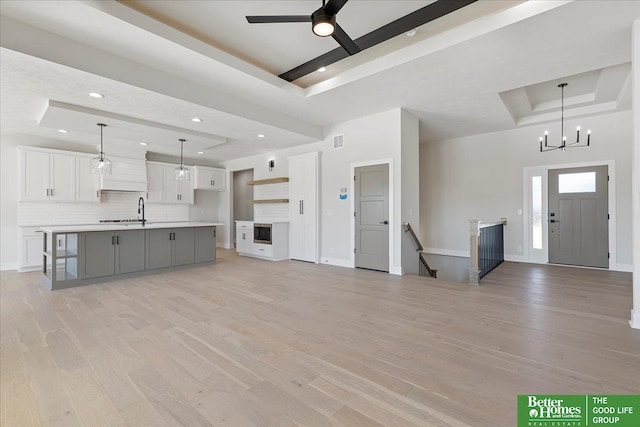 5729 N 196th St, Elkhorn, NE 68022 - unfurnished living room featuring a tray ceiling, light wood-style floors, baseboards, and recessed lighting