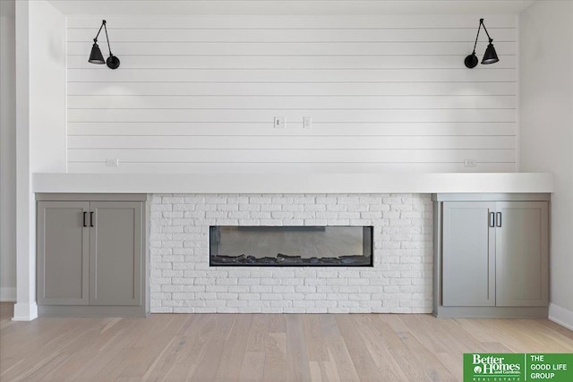 5729 N 196th St, Elkhorn, NE 68022 - detailed view of wood finished floors, a fireplace, and baseboards