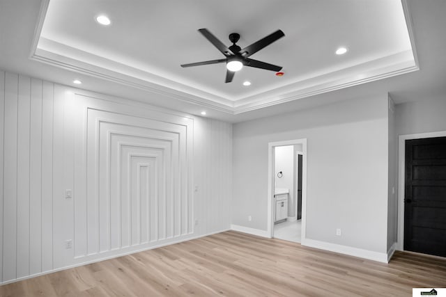7949 Ponce Dr, Lincoln, NE 68516 - unfurnished bedroom featuring a tray ceiling, recessed lighting, light wood-style floors, ensuite bath, and baseboards