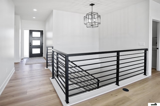 7949 Ponce Dr, Lincoln, NE 68516 - stairs featuring a chandelier, wood finished floors, recessed lighting, and baseboards