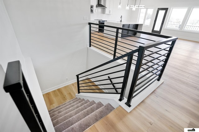 7949 Ponce Dr, Lincoln, NE 68516 - staircase with baseboards and wood finished floors